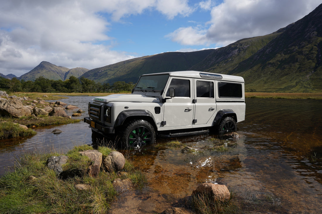 White Land Rover Defender in a lake 